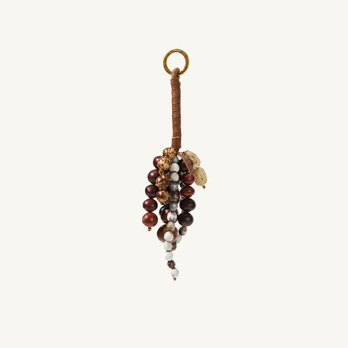 Brown natural seed and leather bag charm with earthy beaded detail