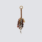 Brown natural seed and leather bag charm with earthy bead details