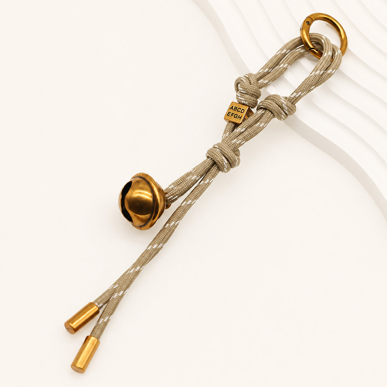 Beige polyester rope bell bag charm