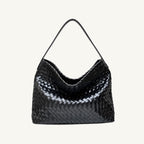 Front view of The Onyx black woven vegan leather slouchy tote bag