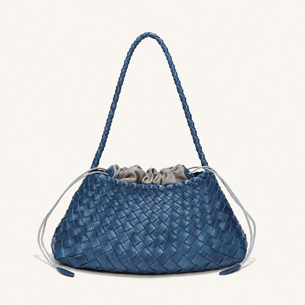 Blue woven vegan leather shoulder bag with relaxed curved structure