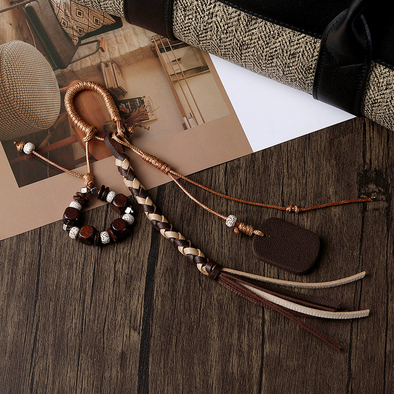 Brown PU beaded tassel bag charm on handbag