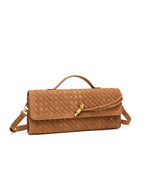Angled view of the brown matte woven vegan leather crossbody clutch with an adjustable shoulder strap.
