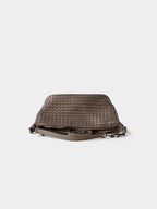 Brown woven genuine leather bag flat lay with adjustable strap