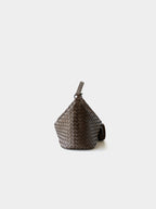Side profile of brown woven leather crossbody hobo bag