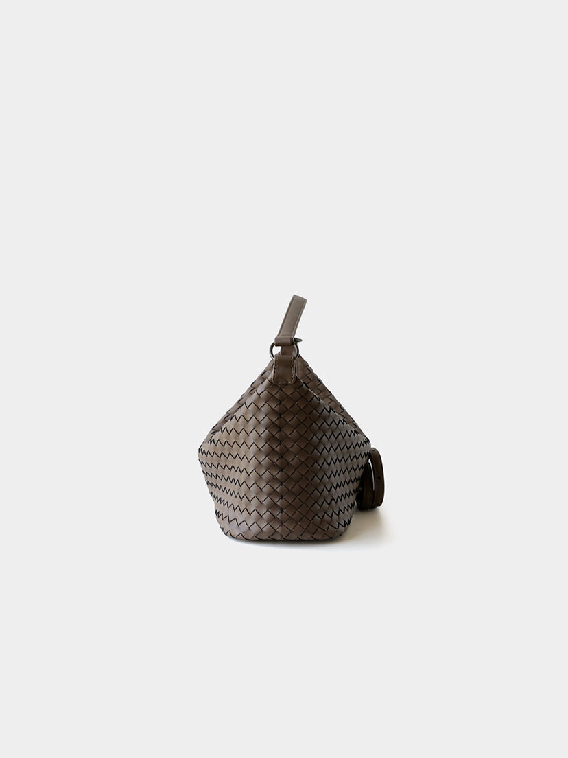 Side profile of brown woven leather crossbody hobo bag