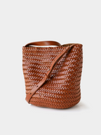 Angled view of the brown handwoven vegan leather tote, showcasing the intricate artisan craftsmanship.