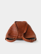 Top-down view of the brown handwoven vegan leather bucket tote, showing its soft yet structured silhouette and premium adjustable strap.