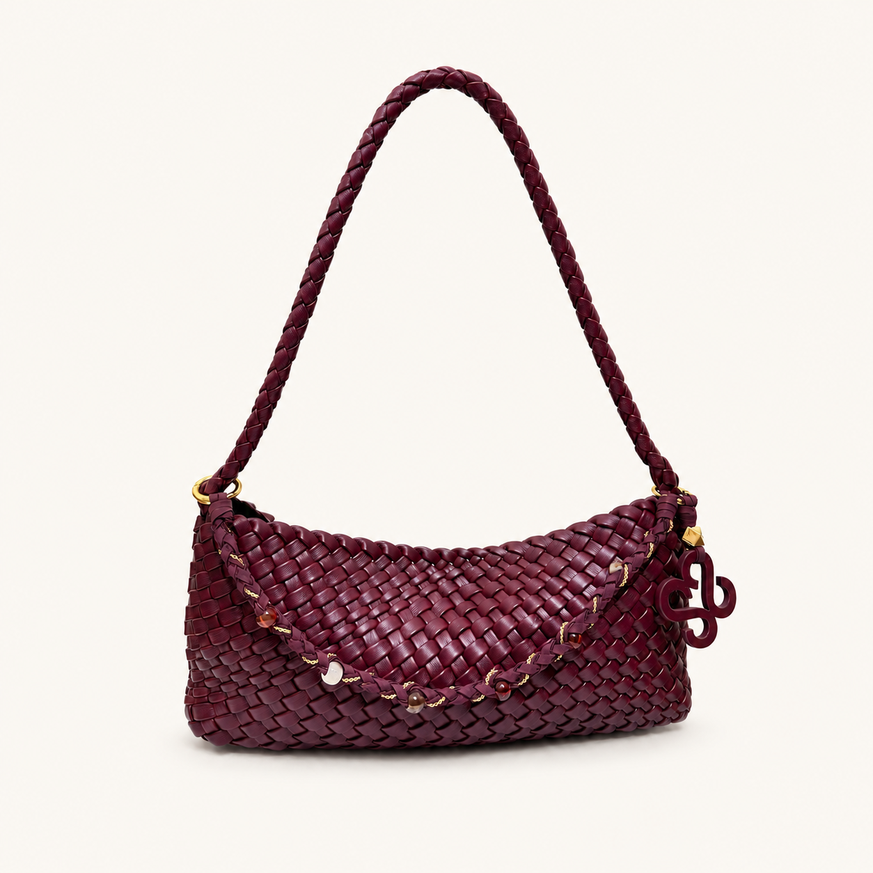 Front view of a burgundy woven vegan leather baguette shoulder bag with braided strap