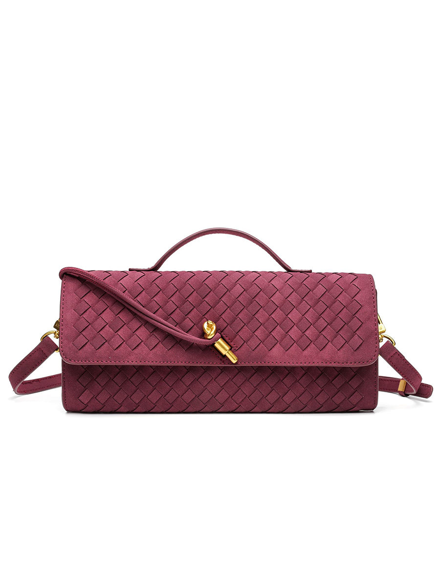 Elegant burgundy red woven vegan leather baguette clutch bag featuring a signature gold knot clasp and top handle.