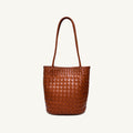Cognac woven vegan leather bucket bag with single top handle, front view
