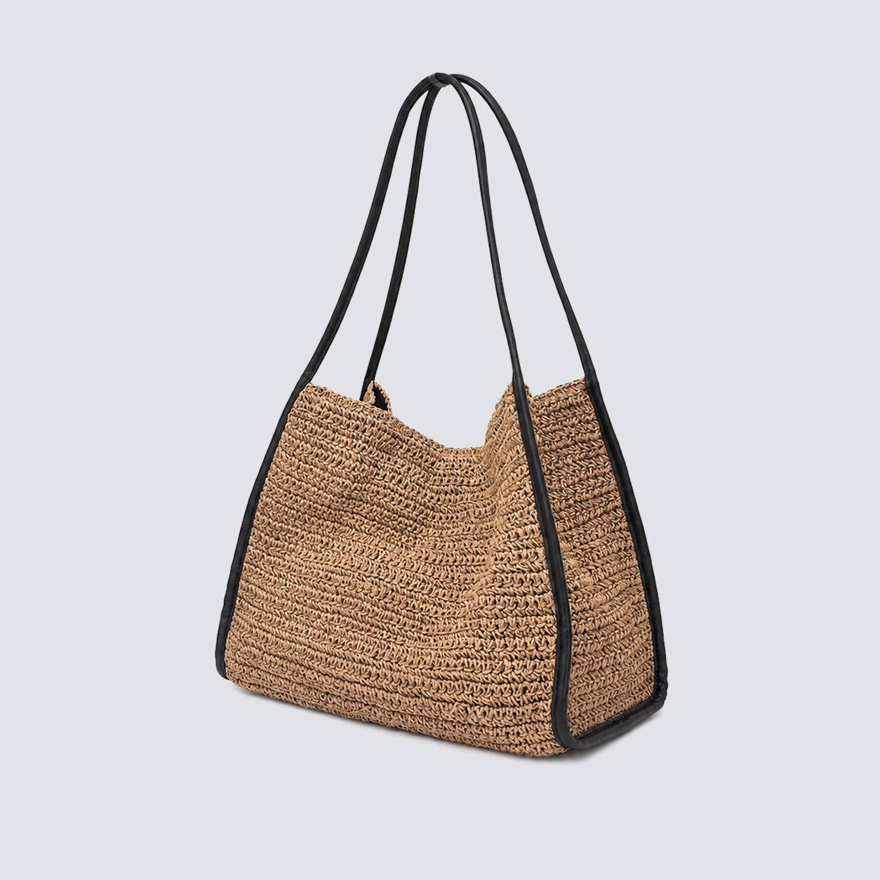 Angled view of the slouchy woven summer straw bag with dual carry straps