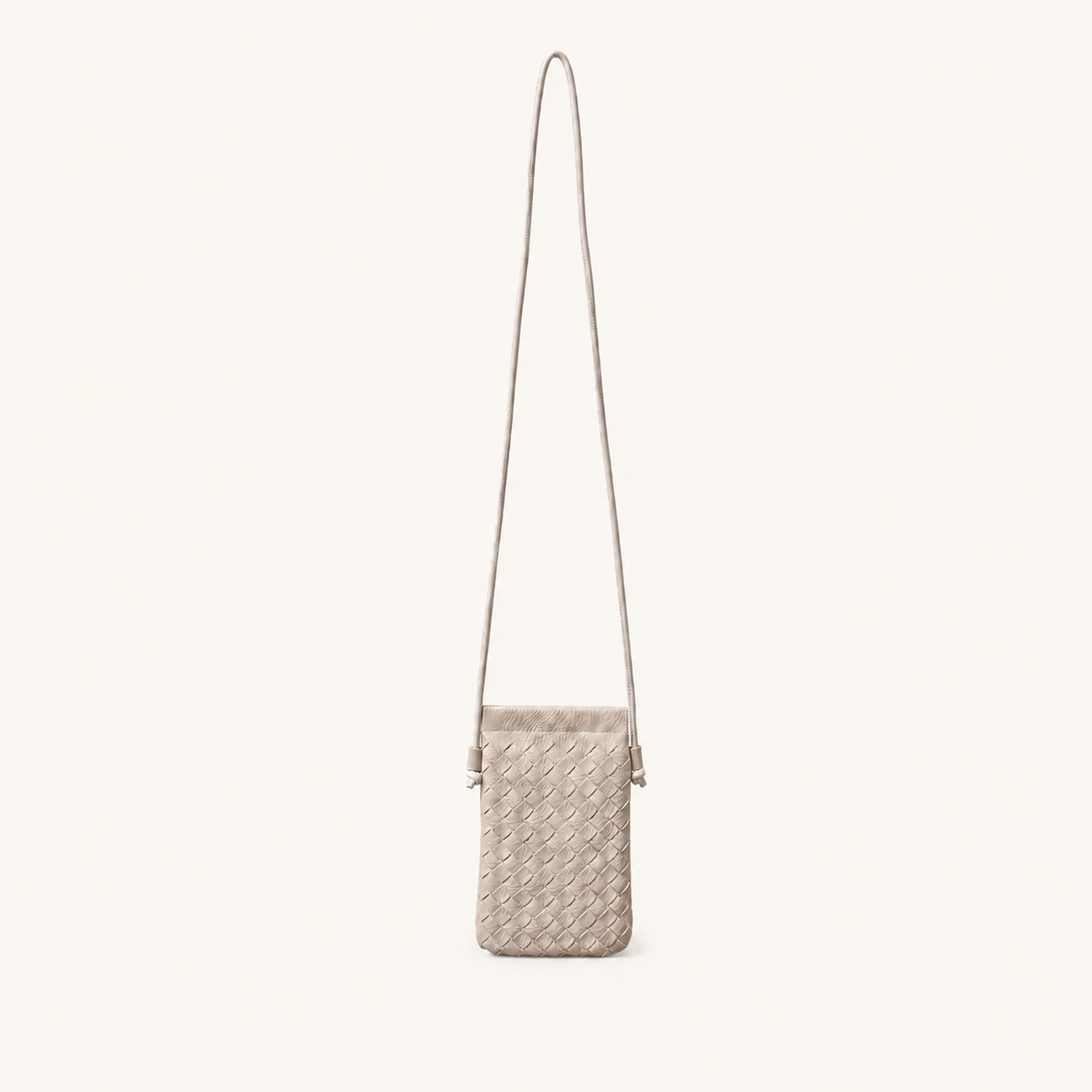 Front view of the woven crossbody phone pouch in a versatile cream off-white shade