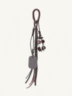 Dark brown vegan leather beaded tassel bag charm with braided cord and decorative beads