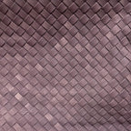 Close-up of the dark plum woven vegan leather texture