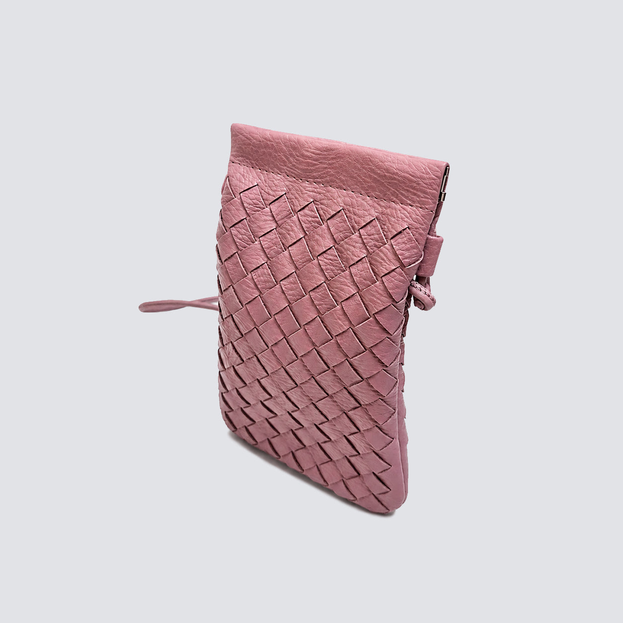 Side angle of the slim and compact dusty rose woven mini crossbody bag