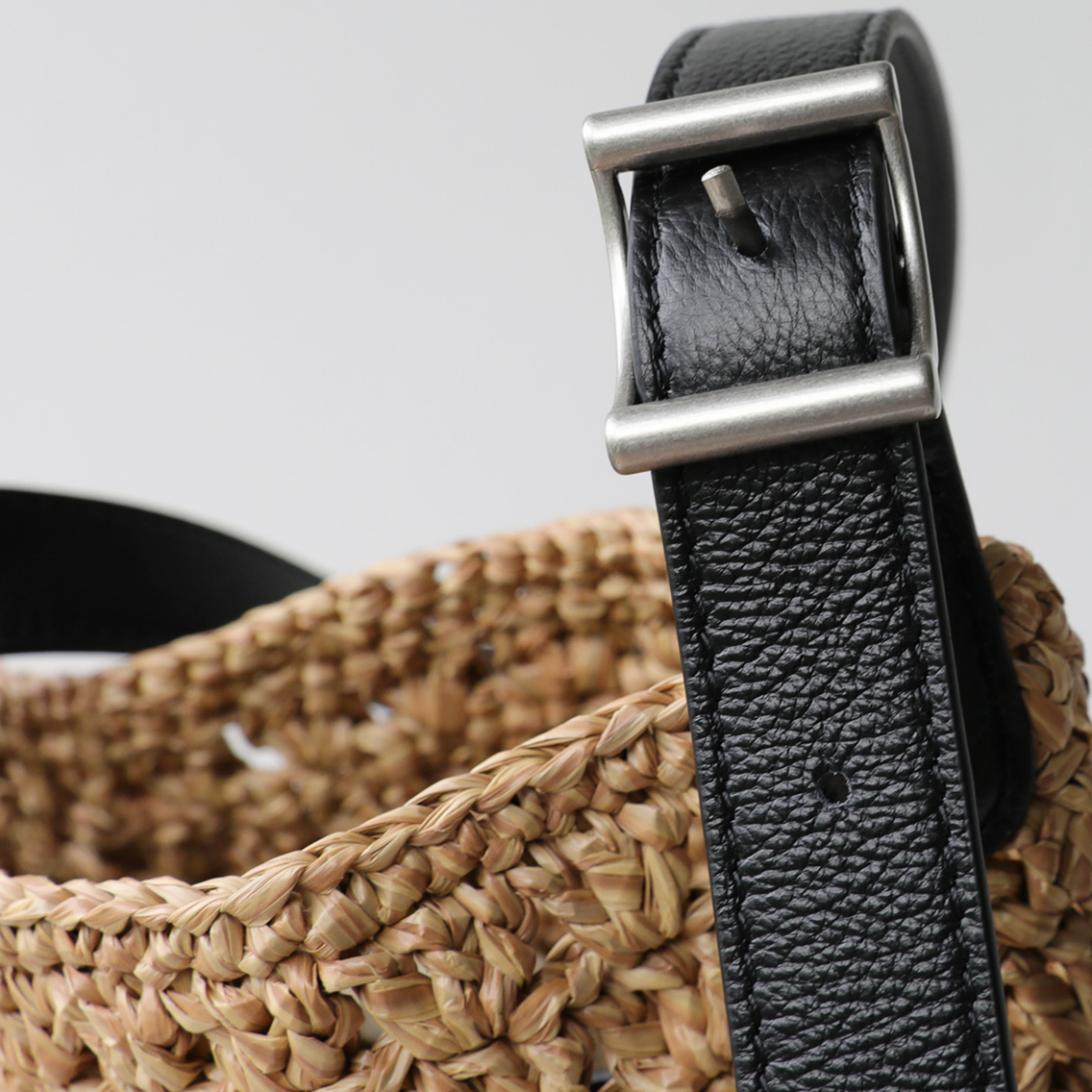 Macro detail of the premium black cowhide leather strap and adjustable metal buckle