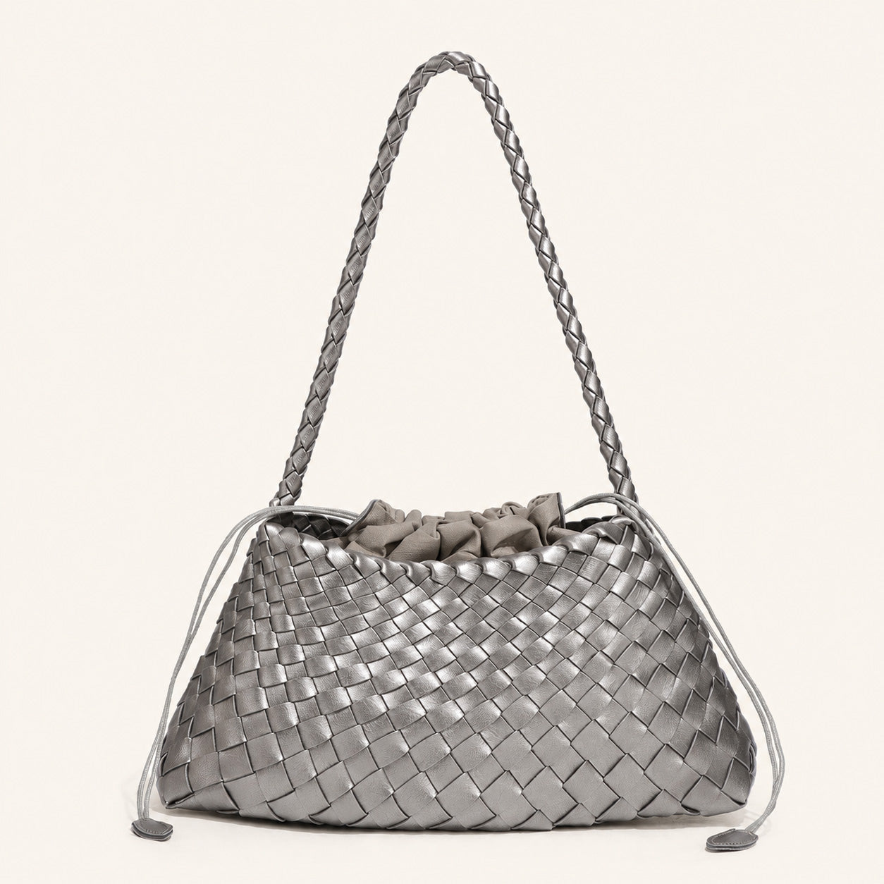 Grey woven vegan leather shoulder bag with minimalist curved shape
