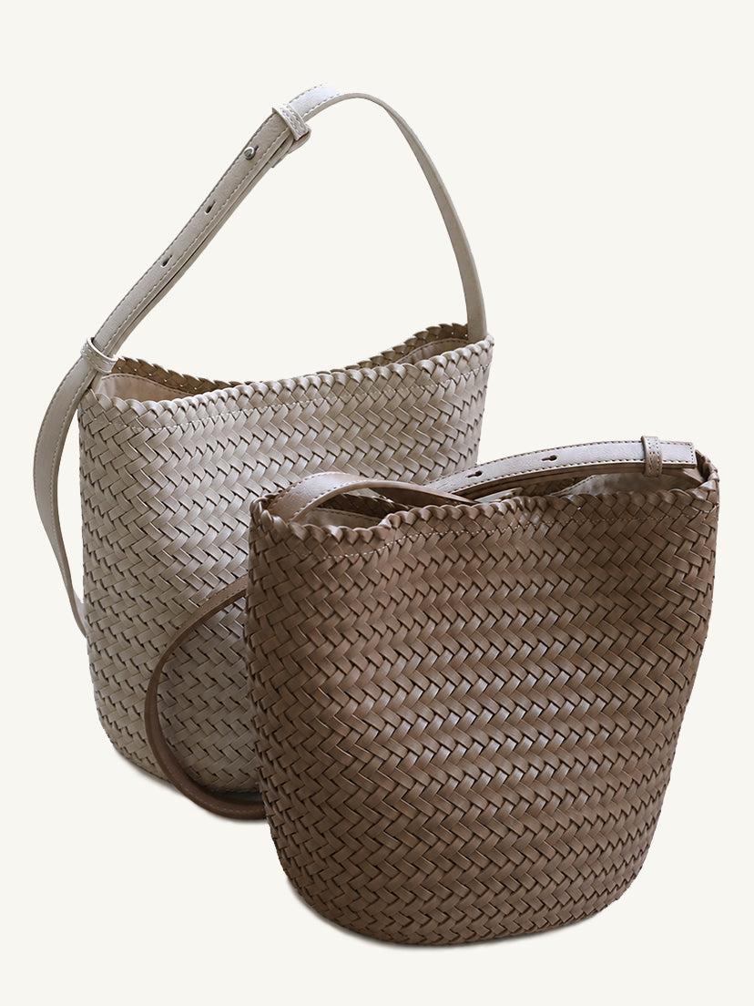 Two handwoven vegan leather tote bags in cream and classic brown displayed together, highlighting the chunky knit texture.