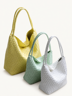 Handwoven vegan leather tote bags in pale yellow, mint green, and white