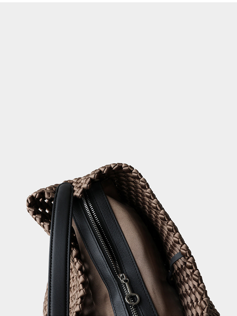 Detailed interior view showing the removable zipper pouch and premium leather strap attachment of the woven tote.