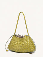 Angled view of lemon yellow woven vegan leather shoulder bag with long strap
