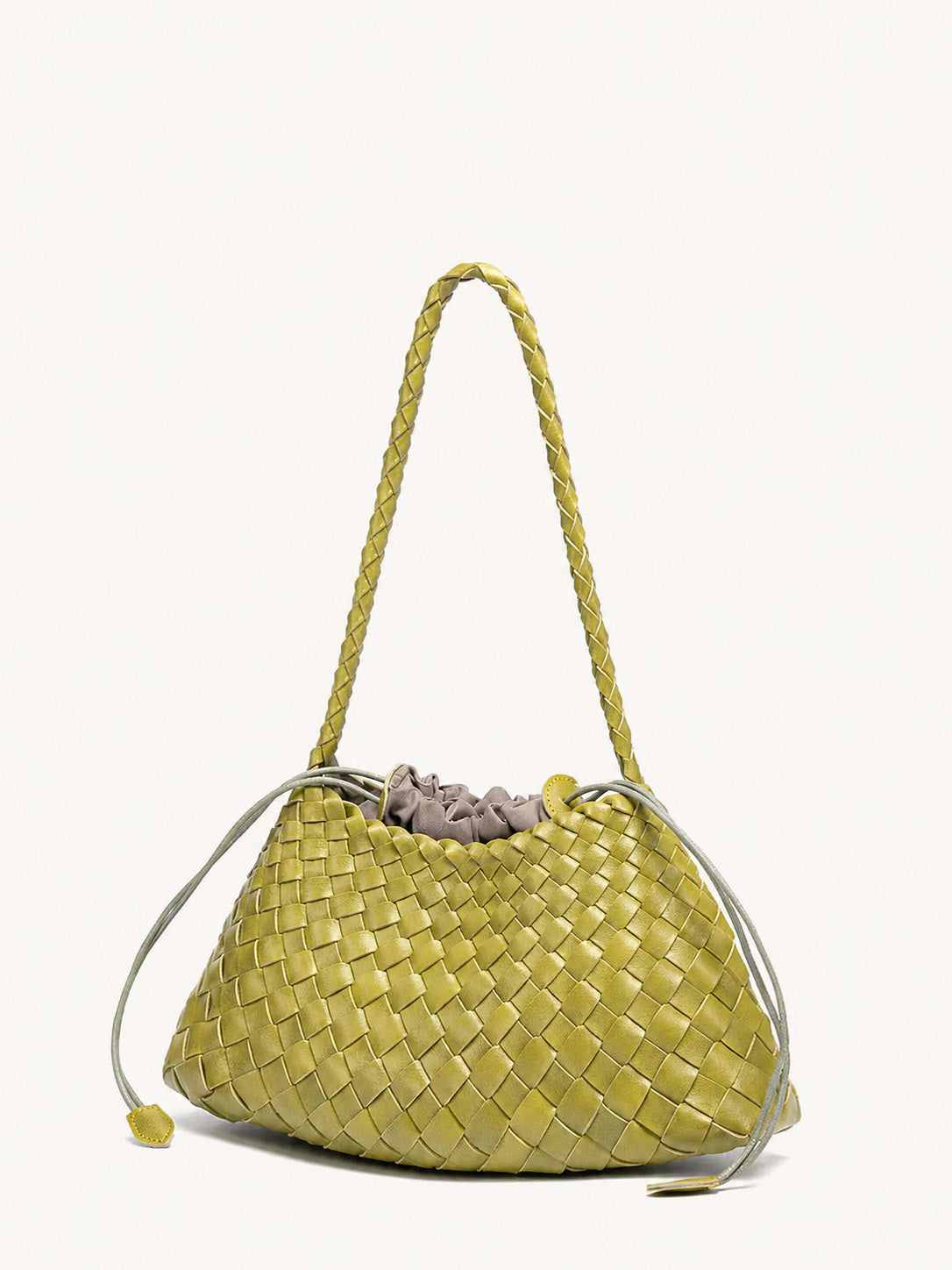 Angled view of lemon yellow woven vegan leather shoulder bag with long strap