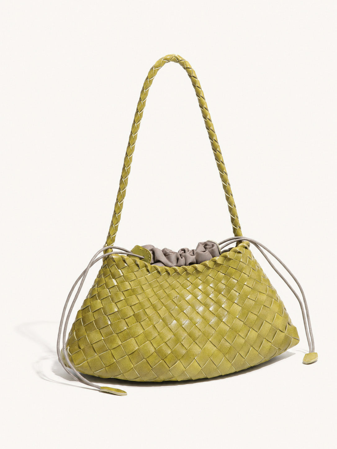Side view of lemon yellow woven vegan leather shoulder bag showing soft structure