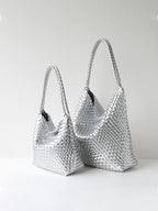 Metallic silver woven vegan leather tote bag shown in size options
