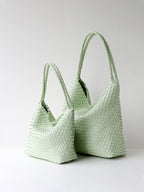 Mint green woven vegan leather tote bag shown in size options