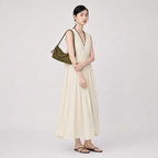 Full length view of a model styling the green woven vegan leather hobo commuter bag