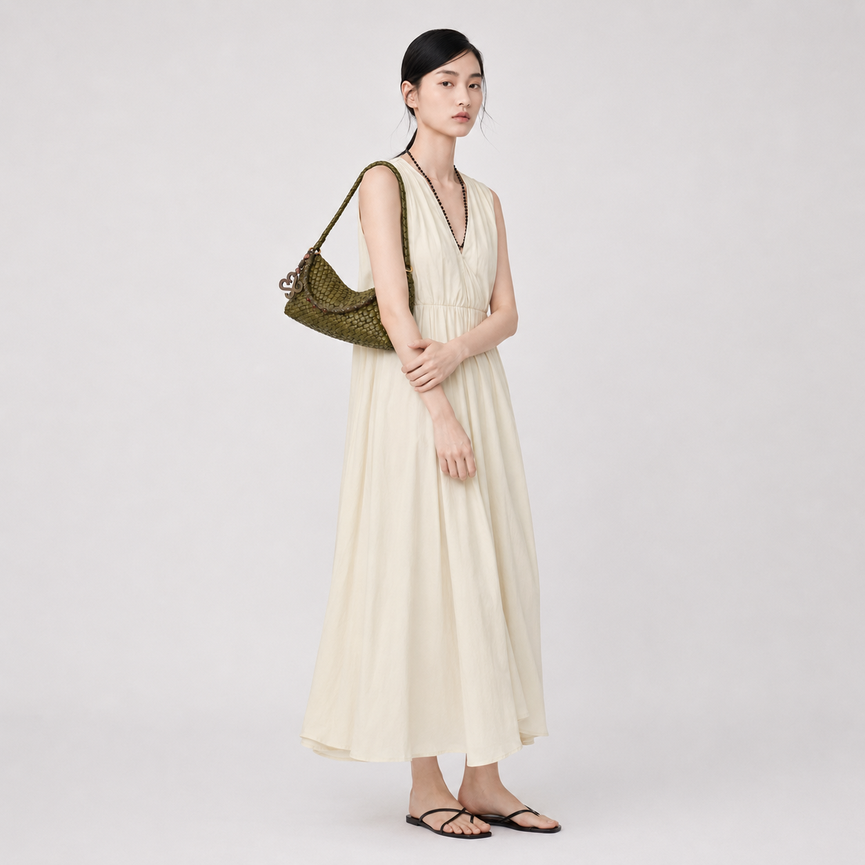 Full length view of a model styling the green woven vegan leather hobo commuter bag