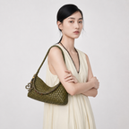 Elegant model in a beige dress carrying the THReAD olive green woven underarm bag