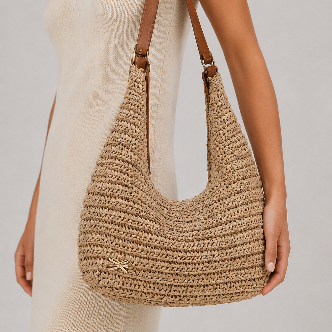 Elegant model in a linen dress wearing the slouchy woven straw hobo bag on her shoulder