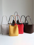 A curated collection of genuine leather lattice woven shoulder bags displayed in white, yellow, red, black, and brown.