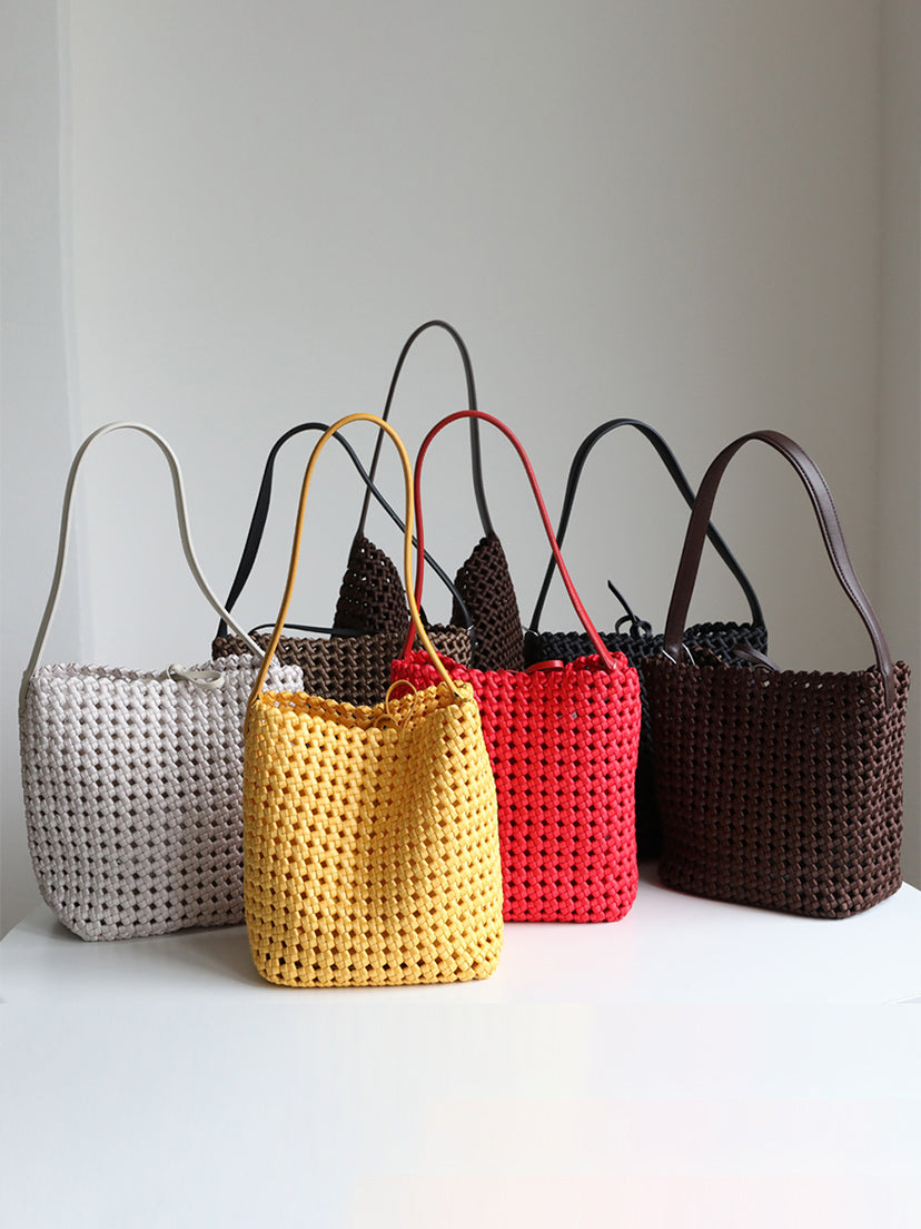 A curated collection of genuine leather lattice woven shoulder bags displayed in white, yellow, red, black, and brown.