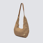 Angled view of the woven summer shoulder bag showing its relaxed silhouette
