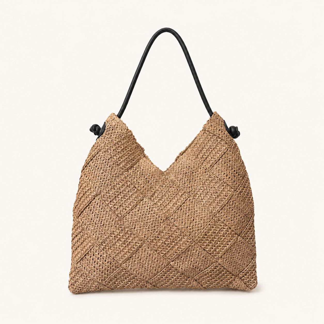 Front view of a natural woven paper straw beach tote bag with a black shoulder strap