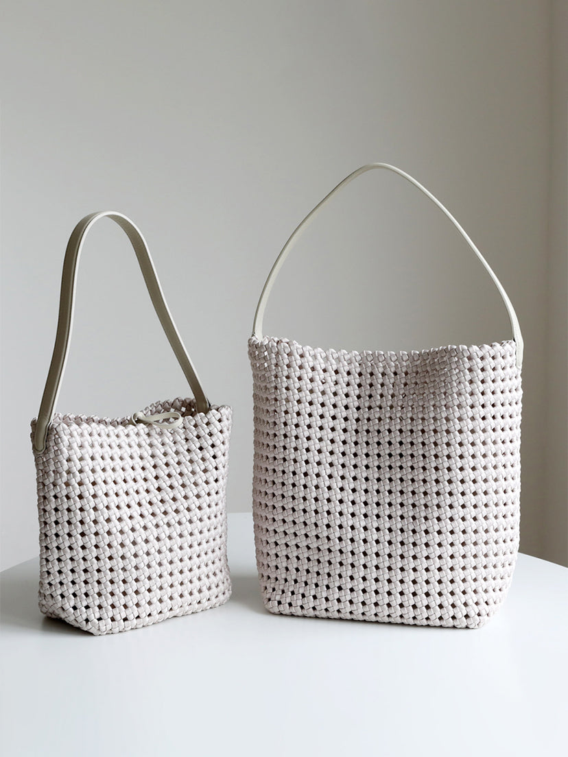 Two off-white genuine leather lattice woven tote bags displayed side-by-side to perfectly compare the small and large sizes.