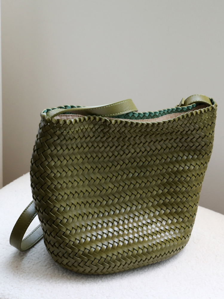 Front view of the olive green artisan woven vegan leather tote bag, highlighting its rich earthy color and sophisticated chunky knit pattern.