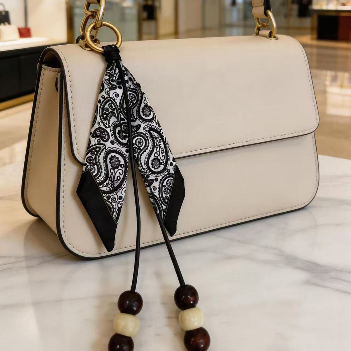 Paisley scarf bag charm on handbag