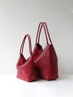Red woven vegan leather tote bag shown in size options