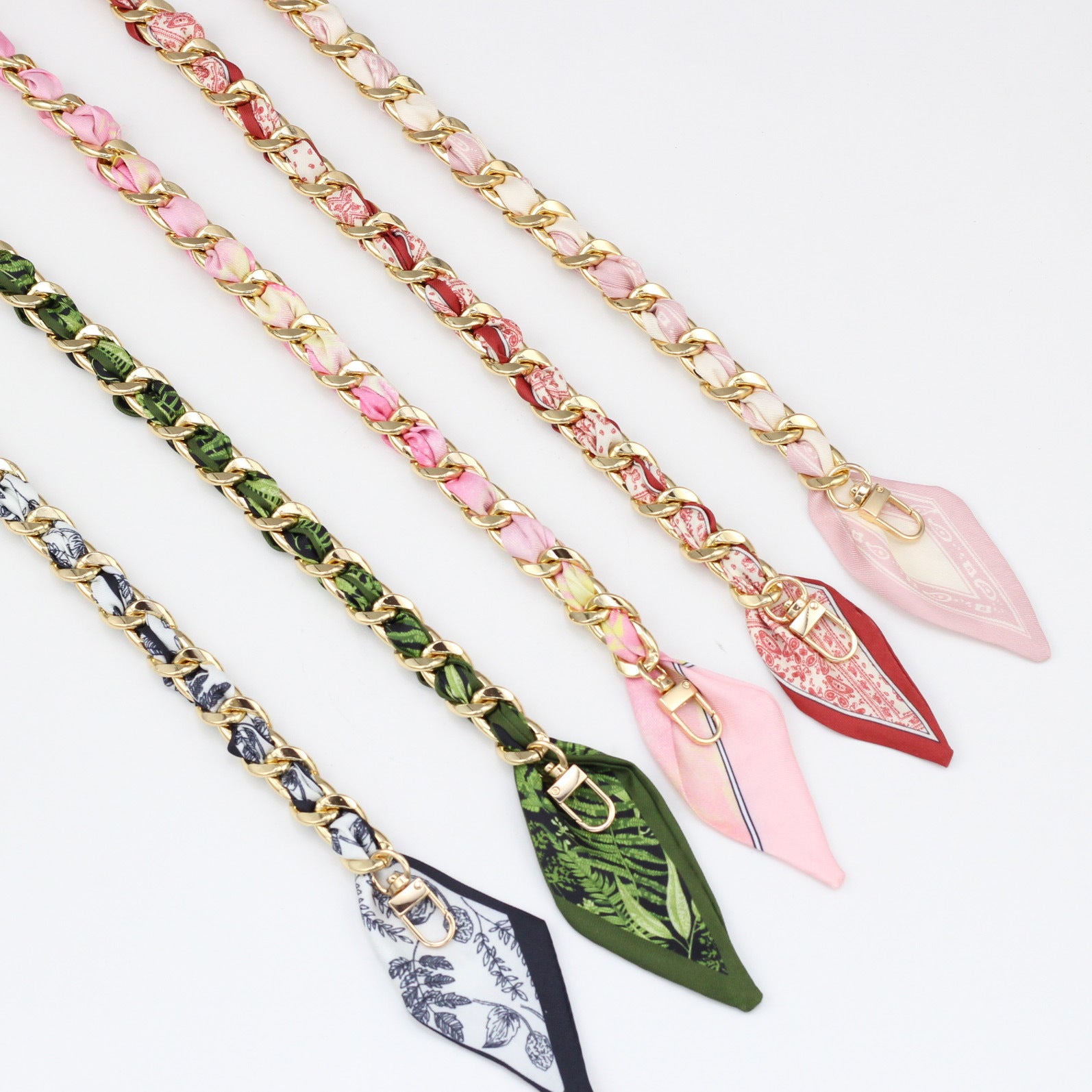 Assortment of gold metal bag straps interwoven with colorful silk scarves