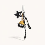 Jet black vegan leather star bag charm with black plush pom keychain and all-black cord tassels