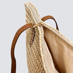 Top-down view highlighting the secure smooth zipper closure of the woven straw tote