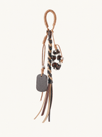 Tan vegan leather beaded tassel bag charm with braided cord and decorative beads