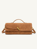 Front view of the tan woven vegan leather baguette bag, featuring a chic gold knot clasp and an elegant top handle.