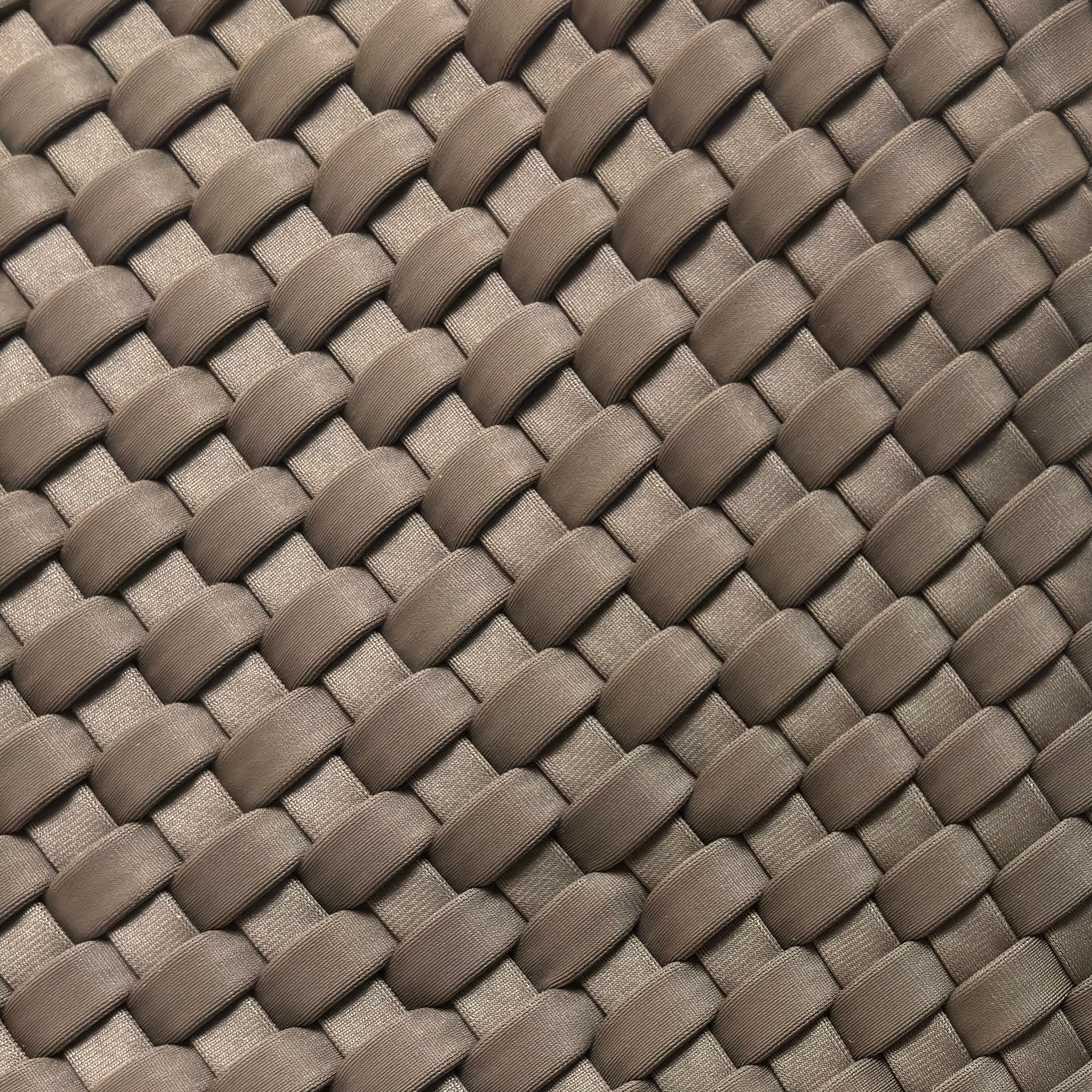 Macro detail of the intricate taupe woven vegan leather pattern