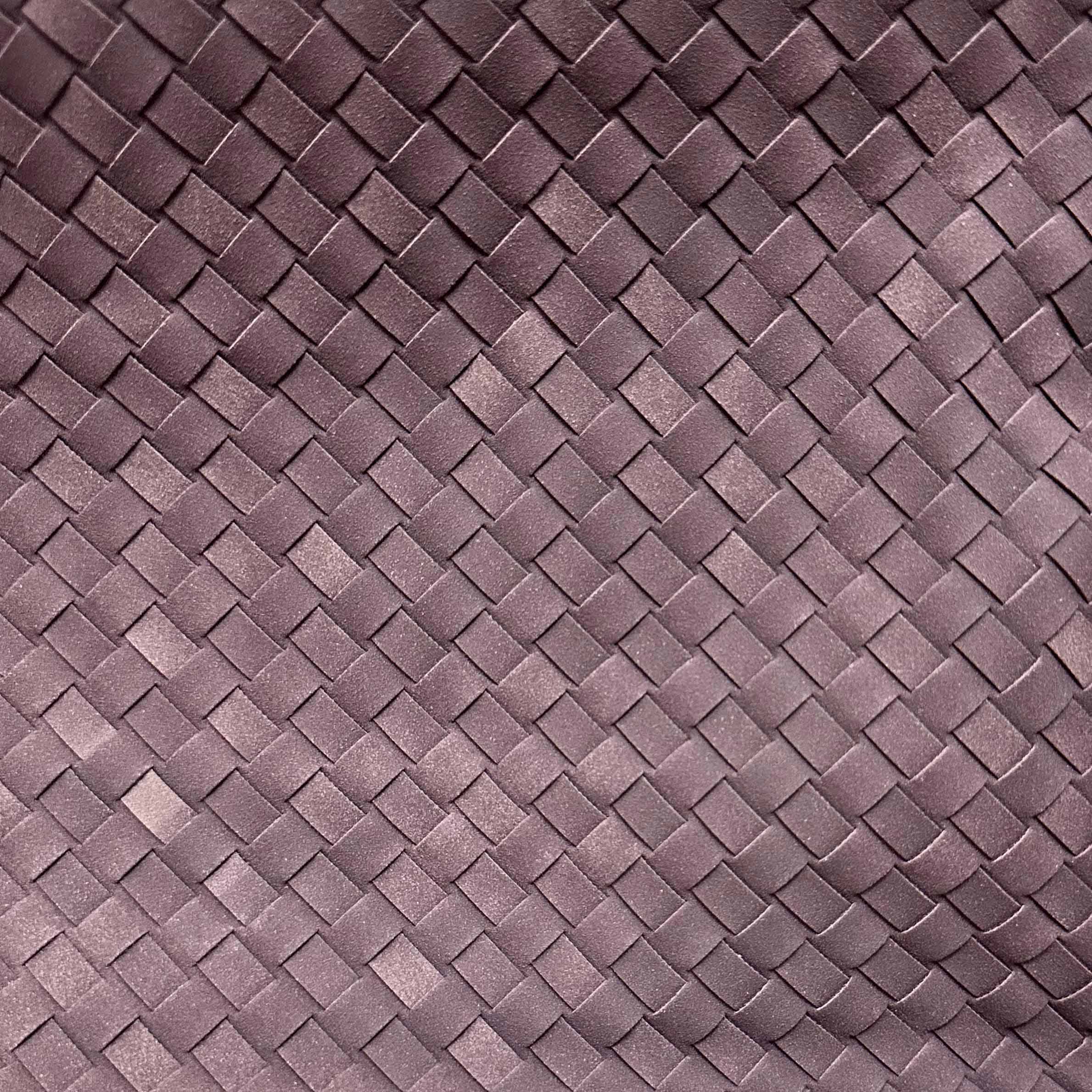 Close-up of the woven vegan leather texture on the aubergine colorway of The Onyx shoulder bag
