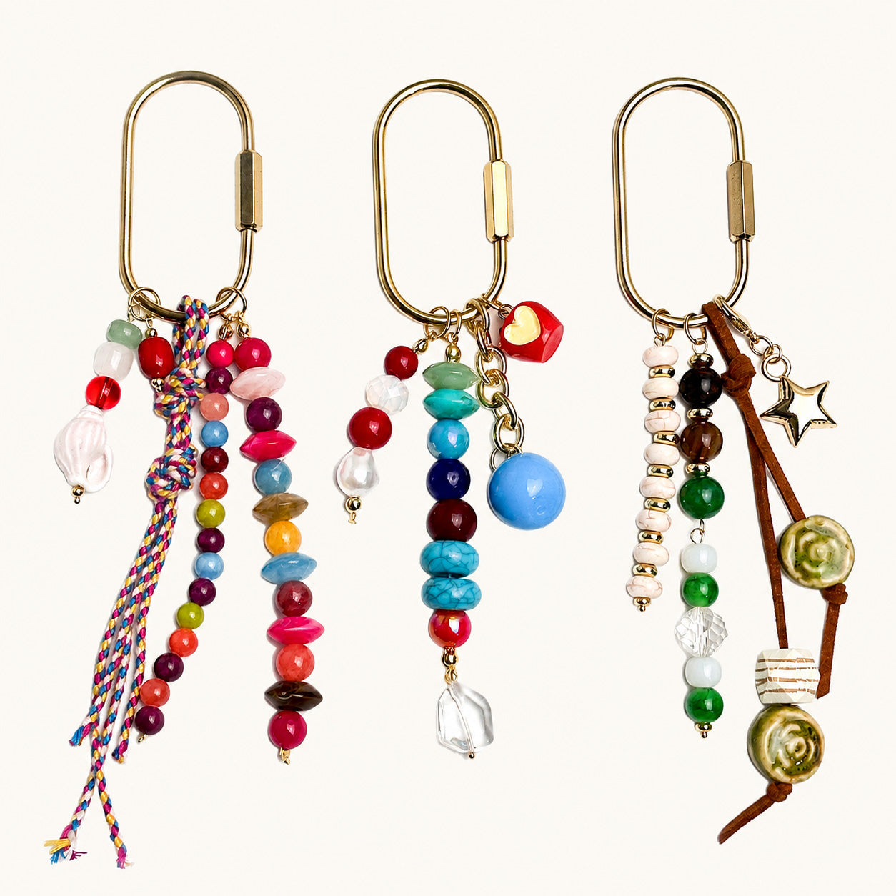 Three multicolor beaded pin bag charms with mixed gemstone-style beads shown together